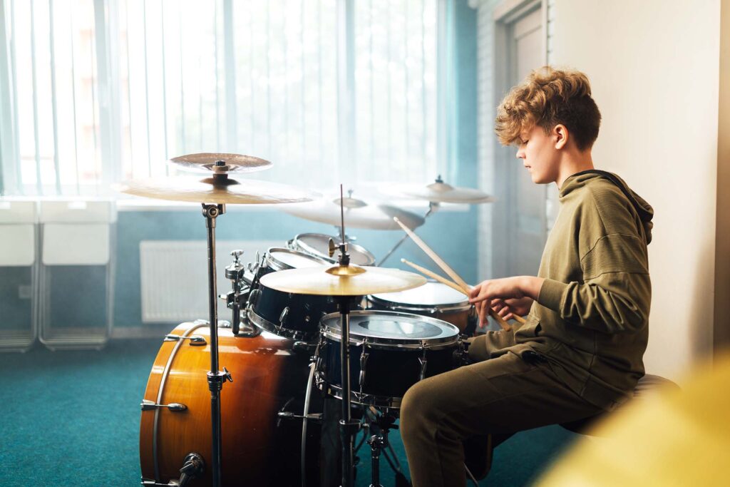 boy-musician-behind-a-drum-kit-LWQJGN4.jpg